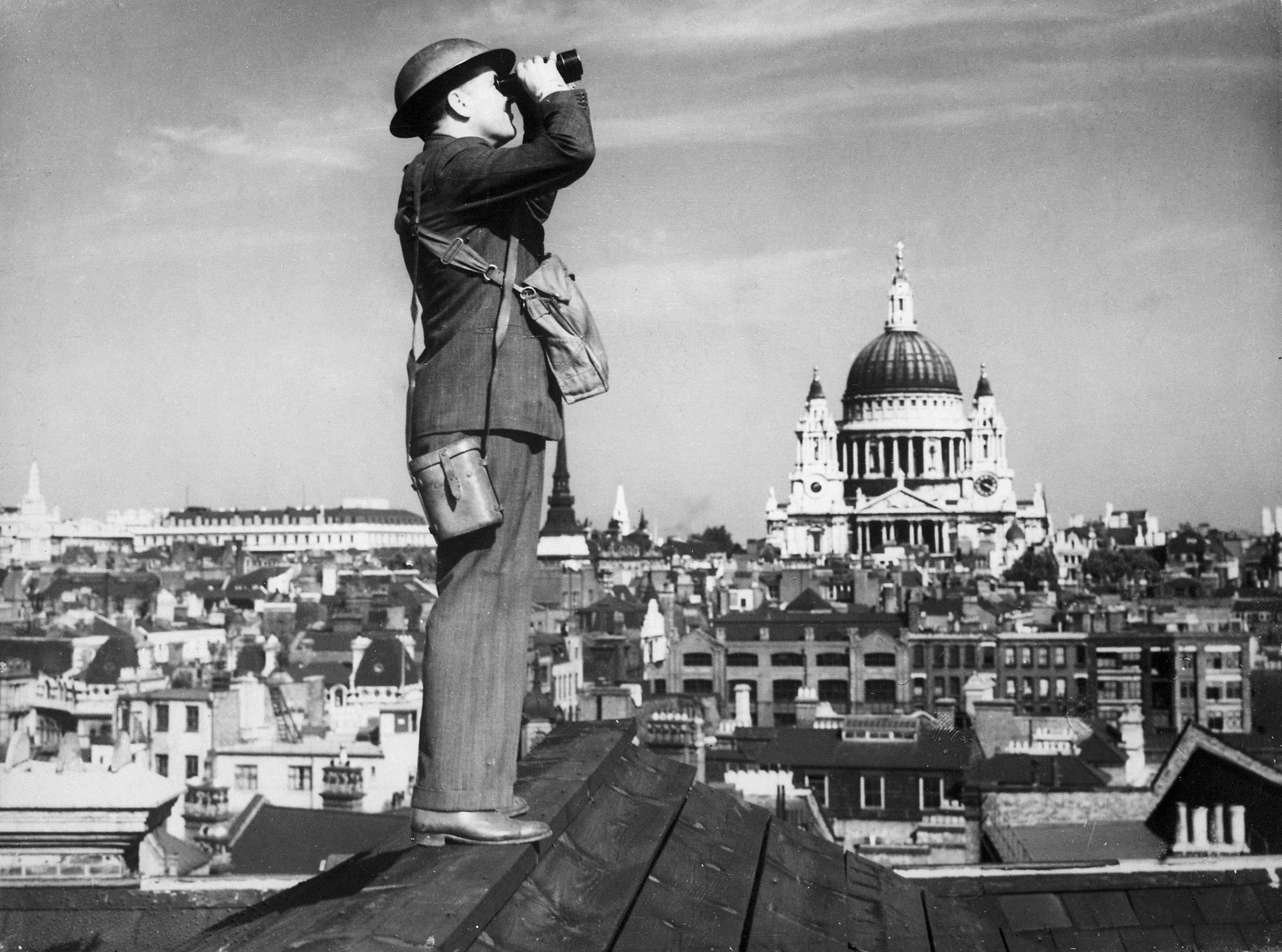 An observer watches the sky over London, with St Paul’s Cathedral behind him.