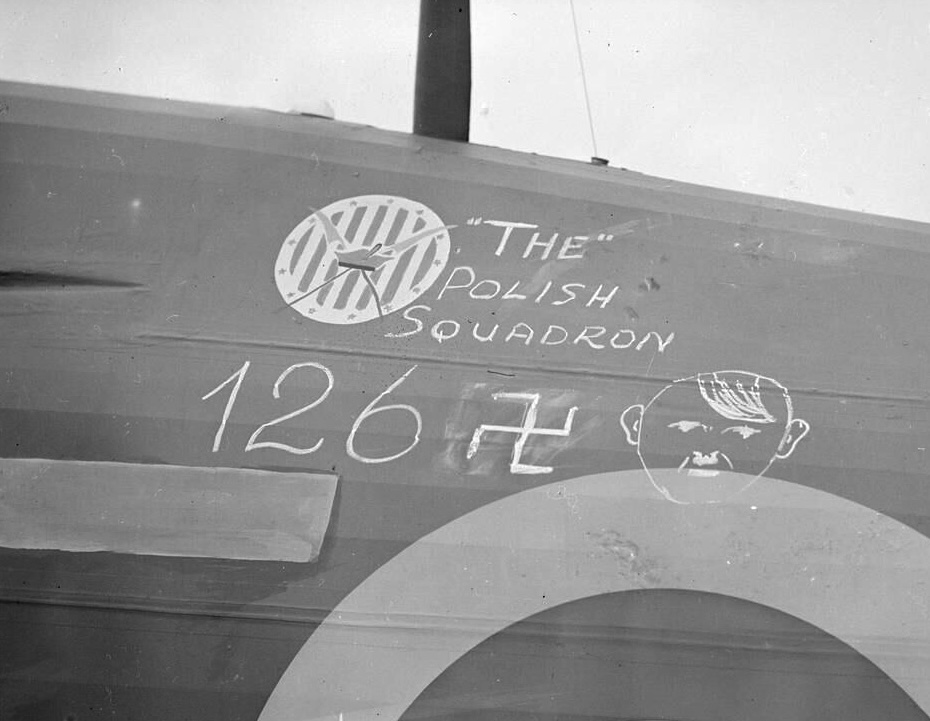 Polish airmen of No. 303 Squadron beside a Hurricane. The painted tally records wartime victory claims.
