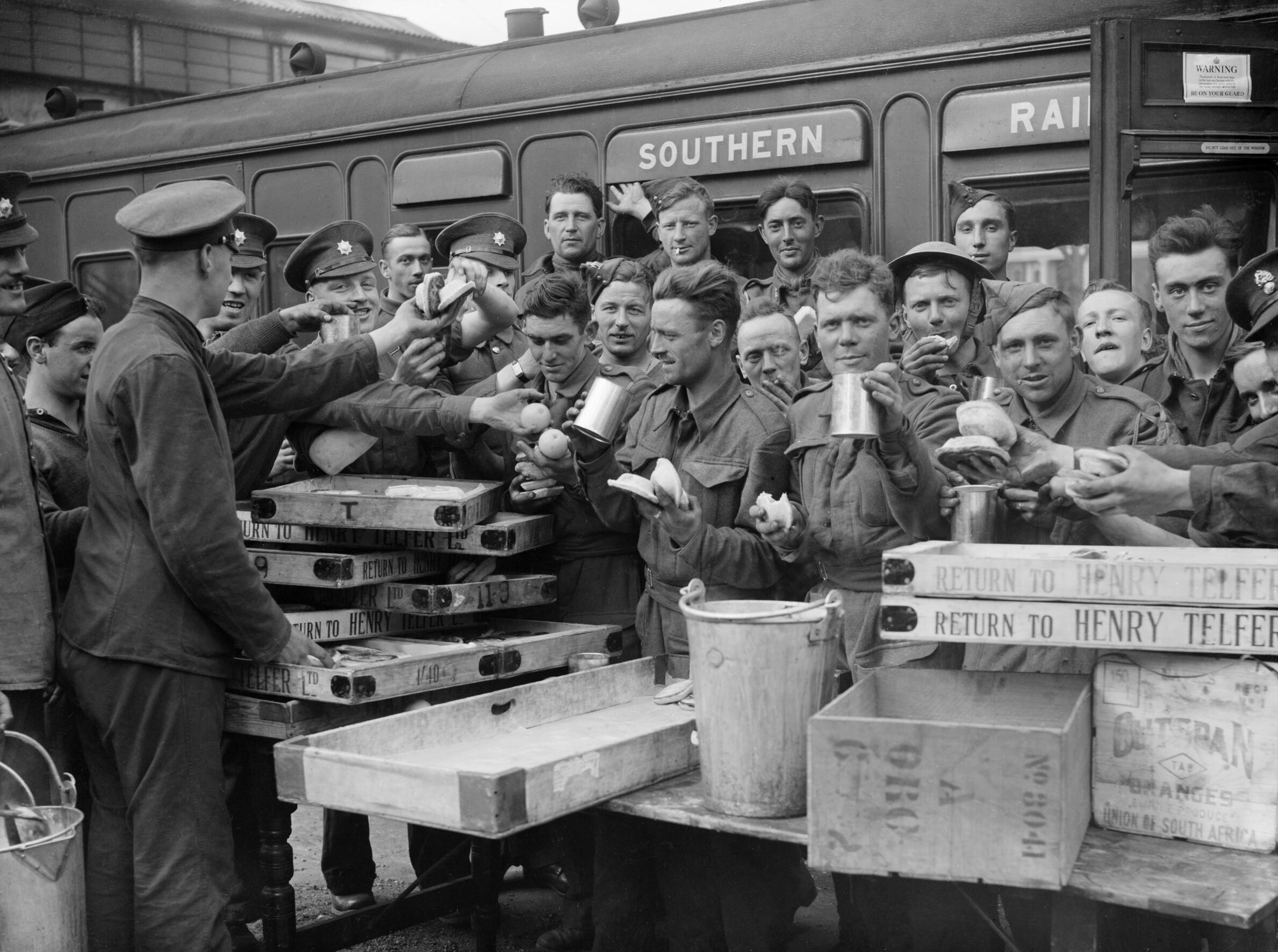 Evacuated troops receive refreshments at Addison Road station, London, 31 May 1940.