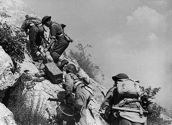 Polish soldiers carry ammunition towards the front at Monte Cassino.