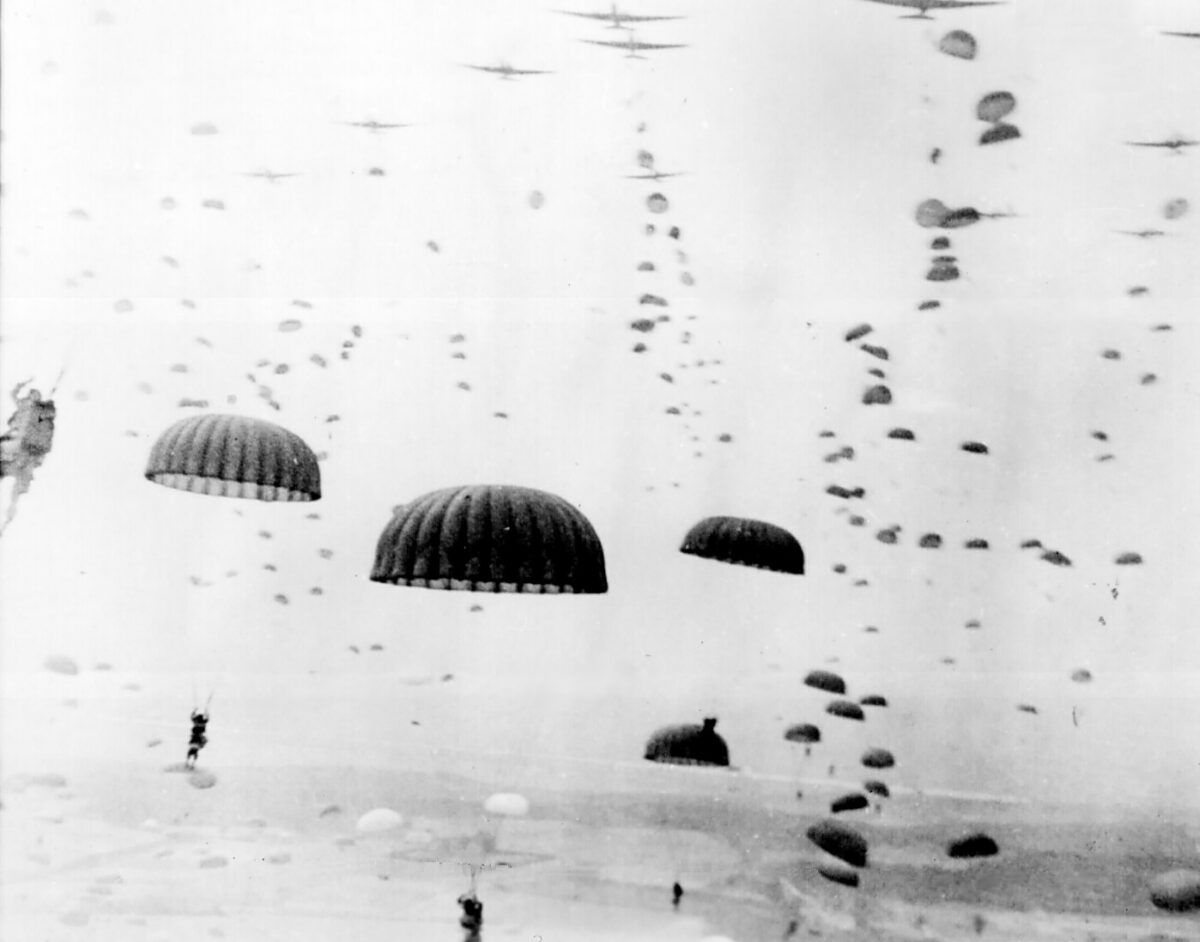 Paratroops descend during Allied airborne operations in the Netherlands, September 1944. U.S. Army photograph; public domain. The image shows the wider operation, not a verified view of Arnhem bridge.