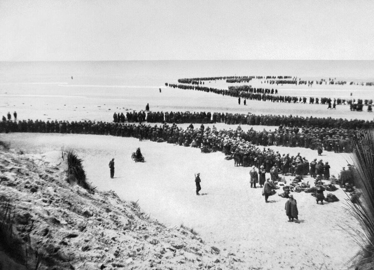 British troops wait on the beach at Dunkirk, May 1940. Wartime photograph, IWM NYP 68075; public domain via Wikimedia Commons.